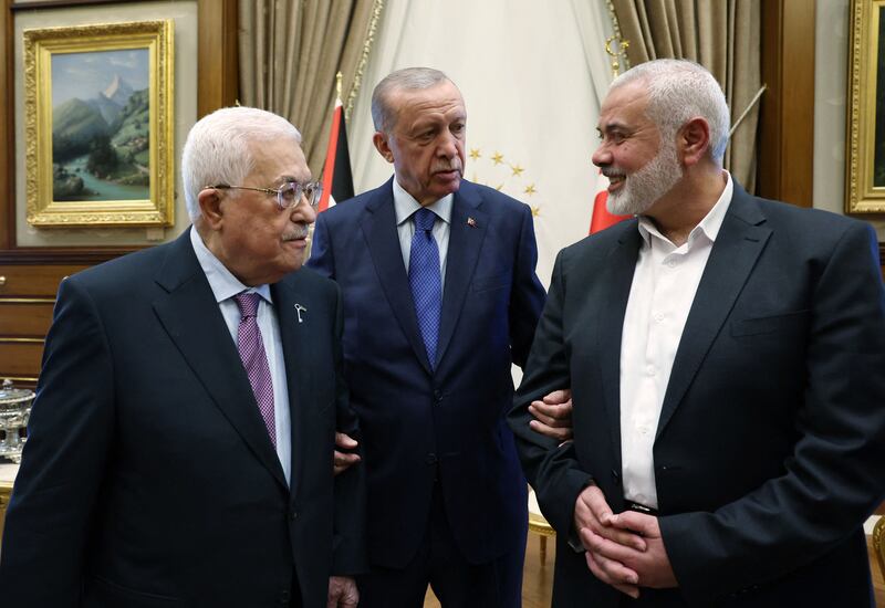 From left, Palestinian President Mahmoud Abbas, Turkish President Recep Tayyip Erdogan and leader of the Hamas movement Ismail Haniyeh meet in Ankara. AFP