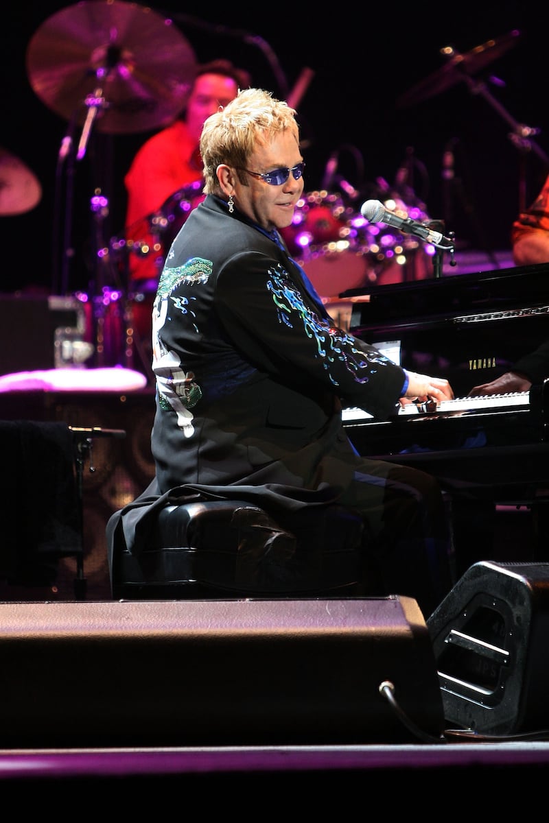 Elton John, wearing a suit with a crocodile and water print, performs his 'The Captain And The Kid Tour' in Sydney, Australia on November 28, 2006. Getty Images