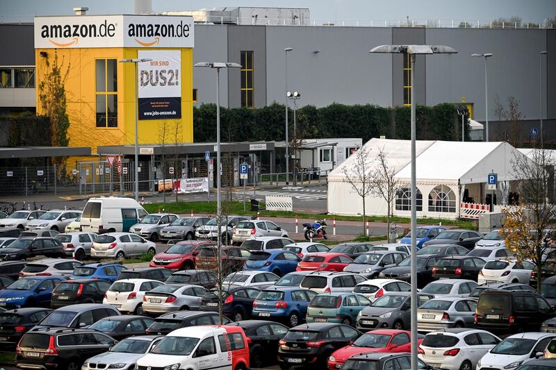 Cars are parked in front of the Amazon logistic center. EPA