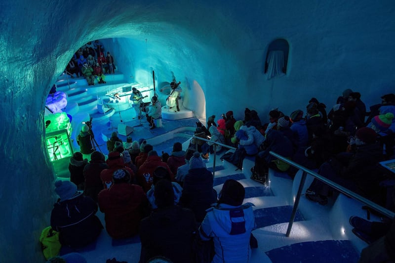 The public listens to musicians perform with the ice instruments during a concert in the "Ice Dome". AFP