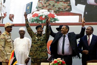 Sudan's head of the Transitional Military Council, Lieutenant General Abdel Fattah Al Burhan, and Sudan's opposition alliance coalition's leader Ahmad Al Rabiah, celebrate the signing of the power sharing deal. Reuters
