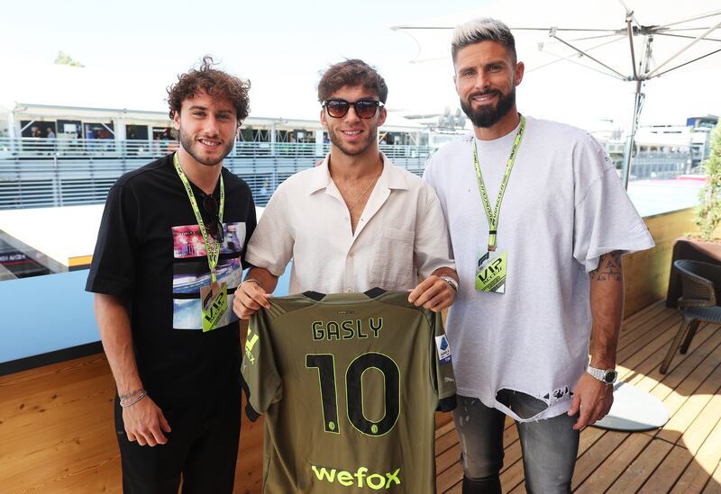 Pierre Gasly poses for a photo with Olivier Giroud and Davide Calabria. Getty