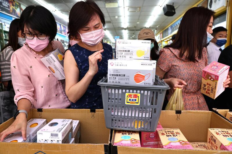 People buy boxes of face masks in Taipei, Taiwan. Reuters