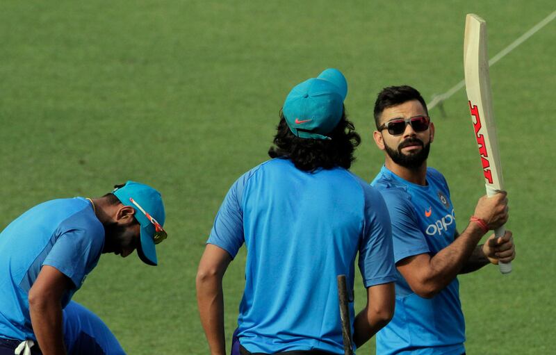 India's Virat Kohli, right, attends a practice session with teammates prior to their first test cricket match against Sri Lanka at Eden Gardens in Kolkata, India, Tuesday, Nov. 14, 2017. Sri Lanka and India are scheduled to play their first test from Nov. 16. (AP Photo/Bikas Das)