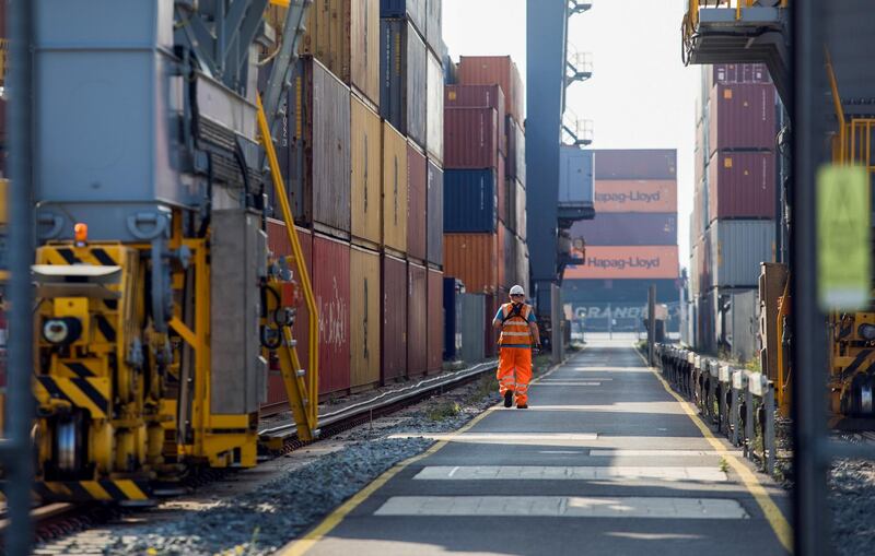 An employee passes between shipping containers on the dockside at London Gateway port, operated by DP World Plc, in Stanford-le-Hope, U.K., on Tuesday, Sept. 22, 2020. France said the European Union should keep pursuing a free-trade agreement with the U.K. while warning that any British violation of the Brexit agreement would end the push. Photographer: Chris Ratcliffe/Bloomberg via Getty Images