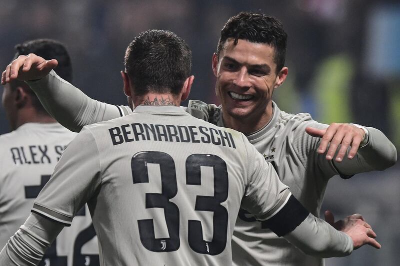 Juventus' Portuguese forward Cristiano Ronaldo (R) celebrates after scoring during the Italian Serie A football match Sassuolo vs Juventus on February 10, 2019 at the Mapei Stadium - Citta del Tricolore stadium in Reggio Emilia. / AFP / Miguel MEDINA
