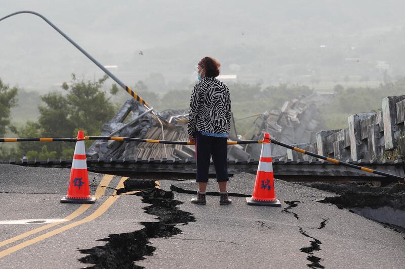 A Taiwanese resident inspects the damaged Gaoliao bridge that collapsed after a magnitude 6. 8 earthquake hit Yuli Township; in Hualien County, Taiwan, 19 September 2022.  The series of earthquakes and aftershocks on 18 September, caused minor structural damage and derailed a train in eastern Taiwan.   EPA/RITCHIE B.  TONGO