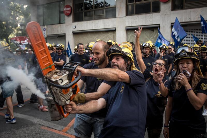 Several firefighters protest outside the headquarters of Tragsa group, owner of the Valencia's regional public companies, to improve their labour conditions in Valencia, eastern Spain. EPA