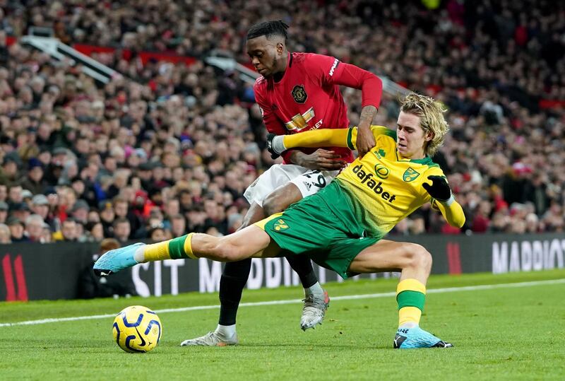 Manchester United's Aaron Wan-Bissaka vies for the ball with Norwich City's Todd Cantwell. Reuters