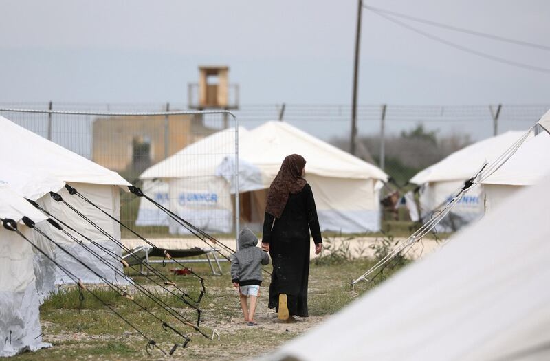 A migrant woman with a child walks by the tents inside a refugee camp in Kokkinotrimithia outside of Nicosia. Cyprus, Thursday, March 5, 2020 The government of ethnically divided Cyprus is ramping up measures to stem migrant inflows amid fears of a surge of new arrivals following Turkey's decision to open its borders to those seeking to enter Europe illegally. (Photo by Danil Shamkin/NurPhoto via Getty Images)