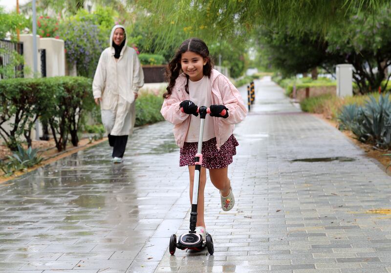 A young scooter rider makes the most of a break in the rain in Dubai. Chris Whiteoak / The National