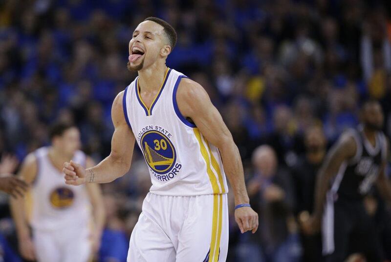 Golden State Warriors guard Stephen Curry reacts after a basket against the San Antonio Spurs on Monday night in his team's victory. Macio Jose Sanchez / AP / January 25, 2016  