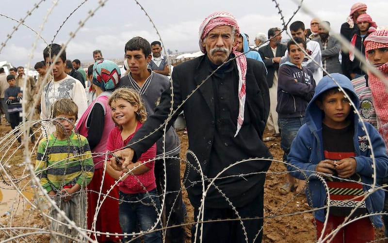 Syrian refugees wait at the Syrian-Turkish border as fears grow that one of the last remaining humanitarian aid crossing points will close. EPA