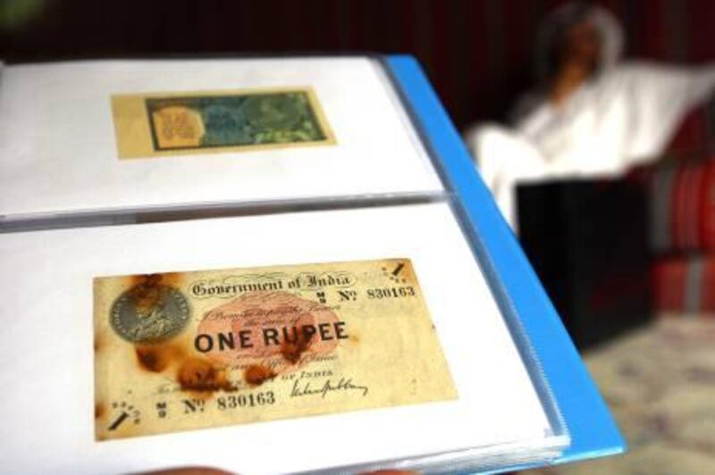 Dubai, United Arab Emirates- June  13, 2011:  Ahmed Saif Al Hassawi displays his  1917's One Rupee Indian note duirng the interview  in Dubai .  ( Satish Kumar / The National )