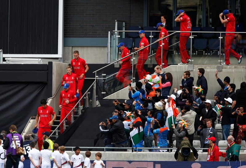 England's captain Alastair Cook, lower left, leads the team out for the presentation to play against India but rain delayed the start in their ICC Champions Trophy final cricket match at Edgbaston cricket ground in Birmingham, England, Sunday, June 23, 2013. (AP Photo/Sang Tan)  *** Local Caption ***  Britain Cricket ICC Trophy Final England India.JPEG-034bb.jpg