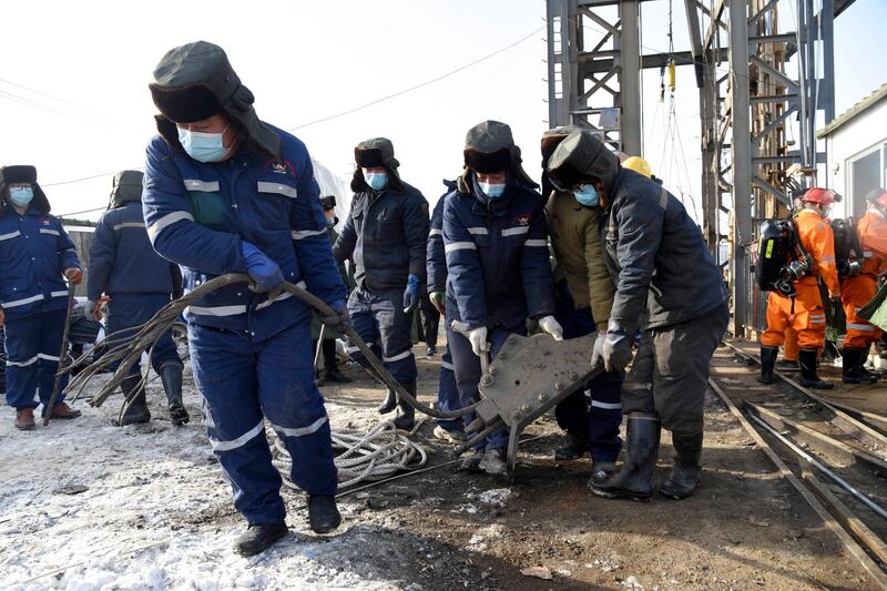 In this photo released by China's Xinhua News Agency, rescuers work at the site of a gold mine that suffered an explosion in Qixia in eastern China's Shandong Province, Tuesday, Jan. 12, 2021. Authorities have detained managers at a gold mine in eastern China where more than 20 workers have been trapped underground following an explosion Sunday. (Wang Kai/Xinhua via AP)