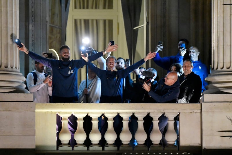 France players Olivier Giroud, left, and Antoine Griezmann, centre, greet supporters in Paris. AFP