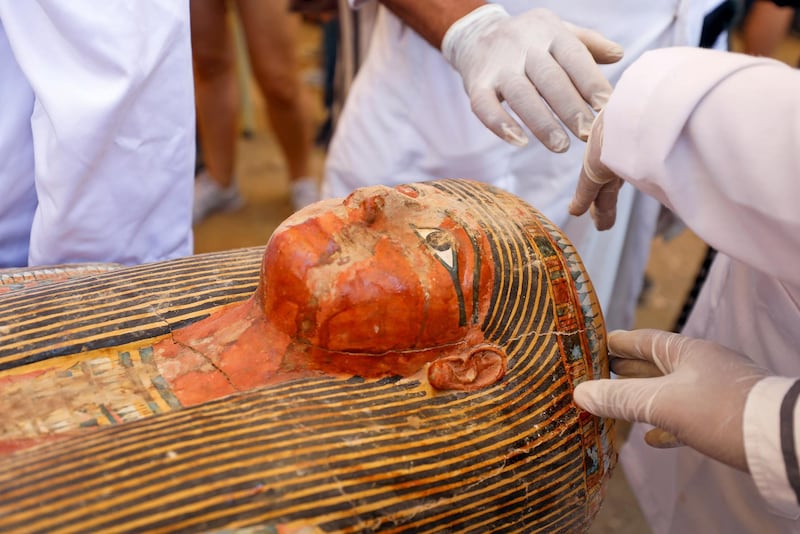 Archaoelogists remove the cover of an ancient painted coffin discovered at Al Asasif Necropolis in the Vally of Kings in Luxor, Egypt. Reuters