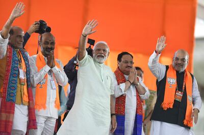 India's Prime Minister Narendra Modi (C) and other Bharatiya Janata Party leaders including Amit Shah (R) wave to supporters at a public meeting in Secunderabad, the twin city of Hyderabad. AFP