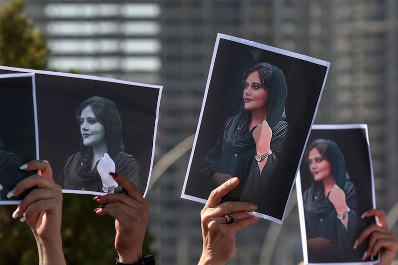 Female demonstrators outside the UN offices in Erbil hold up pictures of Mahsa Amini, 22, who died in the custody of Iranian authorities. AFP