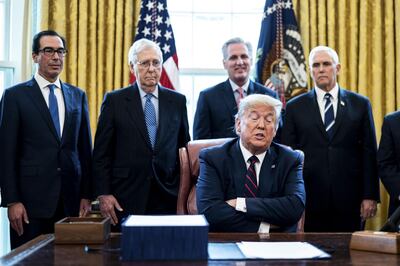 U.S. President Donald Trump speaks before signing the H.R. 748, Coronavirus Aid, Relief, and Economic Security (CARES) Act, in the Oval Office of the White House in Washington, D.C., U.S., on Friday, March 27, 2020. Trump signed the largest stimulus package in U.S. history today, a $2 trillion bill intended to rescue the coronavirus-battered economy after the House approved it earlier. Photographer: Erin Schaff/The New York Times/Bloomberg