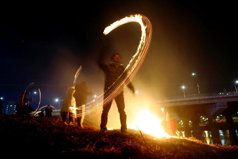 Participants whirl cans filled with burning wood chips during a celebration ahead of Jeongwol Daeboreum (Great Full Moon), which is a traditional Korean holida, at a park in Seoul, South Korea. Reuters