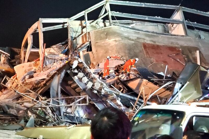 Rescue workers are seen on the site where a hotel being used for the novel coronavirus quarantine collapsed in the southeast Chinese port city of Quanzhou, Fujian province, China March 7, 2020. Picture taken March 7, 2020. cnsphoto via REUTERS. ATTENTION EDITORS - THIS IMAGE WAS PROVIDED BY A THIRD PARTY. CHINA OUT.