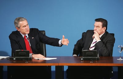 German chancellor Gerhard Schroeder, right, won re-election after opposing George W Bush's invasion in Iraq. Getty Images 
