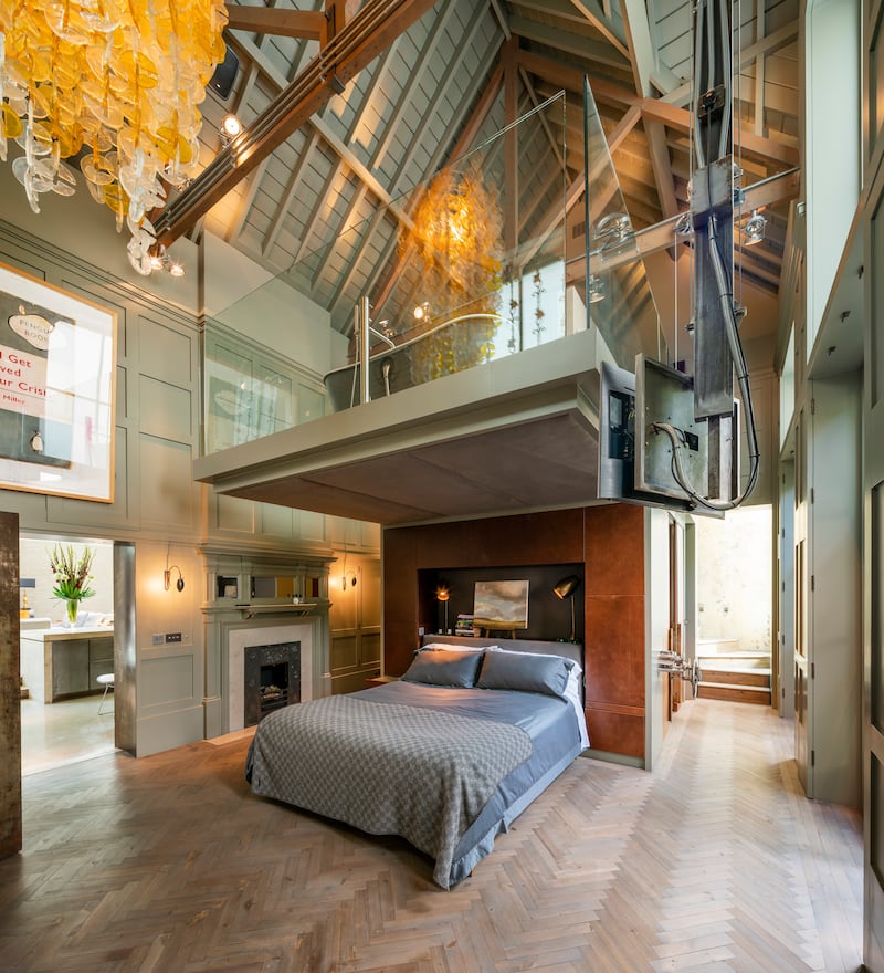 The bedroom features wood panelling reclaimed from The Partridge Fine Art workshop that once existed on the premises.
