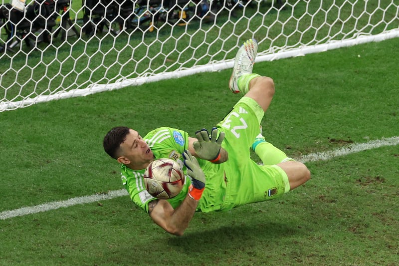 Argentina goalkeeper Emiliano Martinez saves from Kingsley Coman of France in the penalty shoot-out. Getty