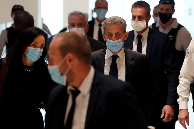 Former French President Nicolas Sarkozy, wearing a protective face mask, arrives for the verdict in his trial on charges of corruption and influence peddling, at Paris courthouse. Reuters