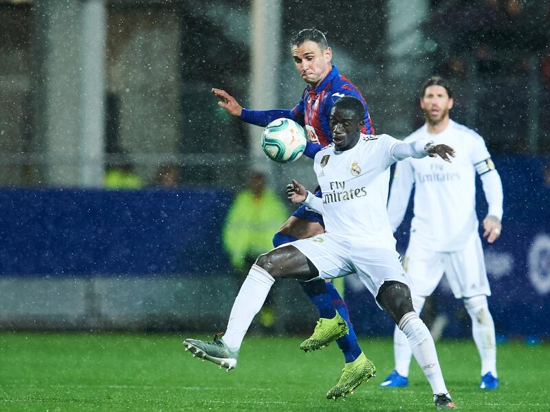 Real Madrid full-back Ferland Mendy competes for the ball with Eibar's Kike Garcia. Getty Images