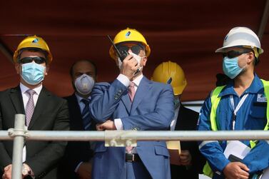 Iraq's Prime Minister Mustafa al-Kadhimi uses a walkie-talkie at the central station gas processing plant at Rumaila oilfield in Basra, Iraq, November 5, 2020. REUTERS/Essam Al-Sudani