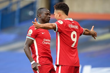Sadio Mane of Liverpool celebrates with Roberto Firmino after scoring at Chelsea. EPA