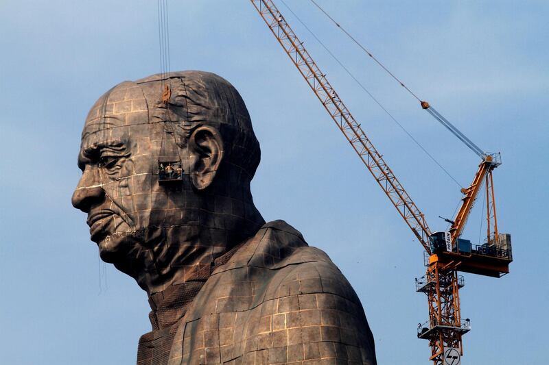 The under construction statue of unity stands facing Sardar Sarovar Dam at Kevadiya Colony, about 200 kilometers (125 miles) from Ahmadabad, India, Thursday, Oct. 18, 2018. The Statue of Unity, a 182-meters tall tribute to Indian freedom fighter Sardar Vallabhbhai Patel, will be inaugurated on Oct. 31 by Indian Prime Minister Narendra Modi and is slated to be the one of the world's tallest statue. (AP Photo/Ajit Solanki)
