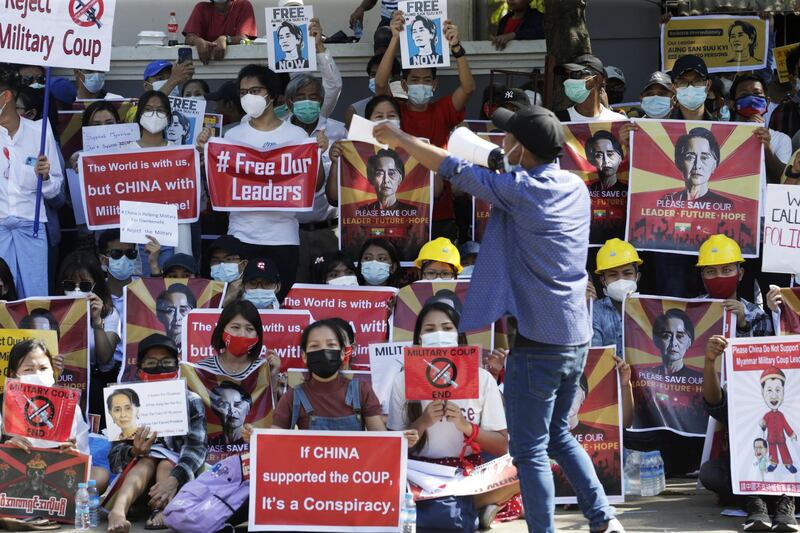 A protester holds a placard calling for the release of detained Myanmar State Counselor Aung San Suu Kyi during a protest against the military coup outside the Chinese Embassy in Yangon. EPA