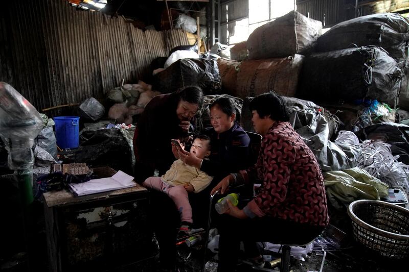 Three women and a child watch the news on a mobile phone in Shanghai, China. Aly Song / Reuters
