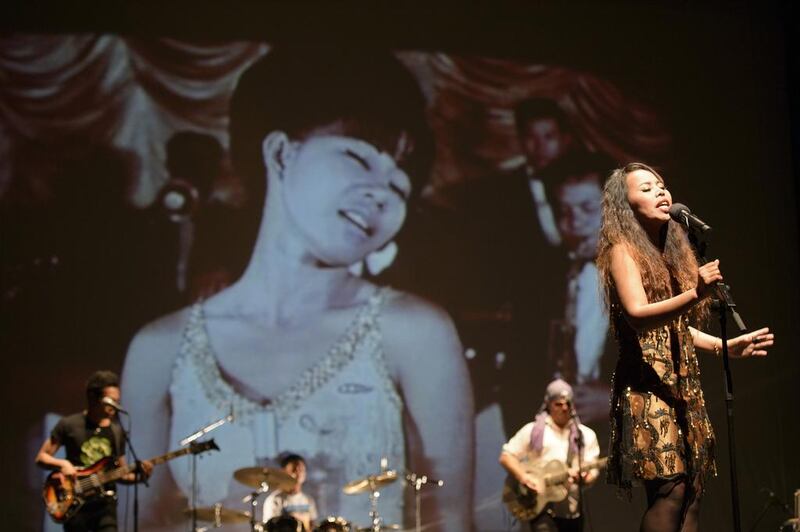 The Cambodian Space Project performing live against a projected backdrop of images from the lost pre-Khmer Rouge years of Cambodian music. Courtesy Michael Laub / The Cambodian Space Project

