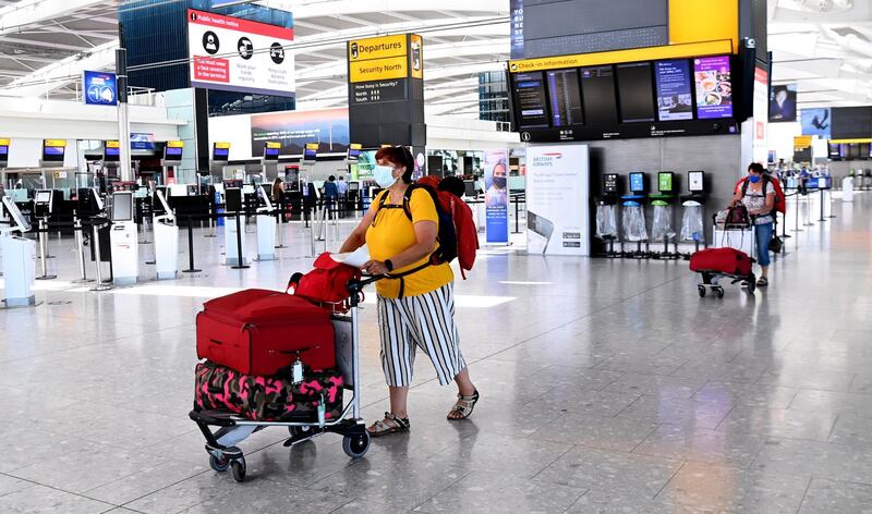 epa09255107 A traveller at Heathrow airport in London, Britain, 08 June 2021. Extra flights to Britain have been departing Portugal as holidaymakers scrambled to leave on the last day before the country moved to the amber travel list. Many travellers missed the deadline and will have to quarantine for up to ten days.  EPA/ANDY RAIN