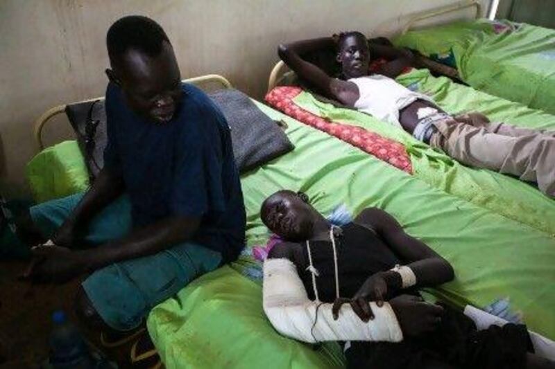 Sudan People's Liberation Army soldiers Chol Lang, 24, Bieth Keer, 22, and Majok Deng, 28, who were injured in a rebel ambush, rest inside a ward at a military hospital in Juba.