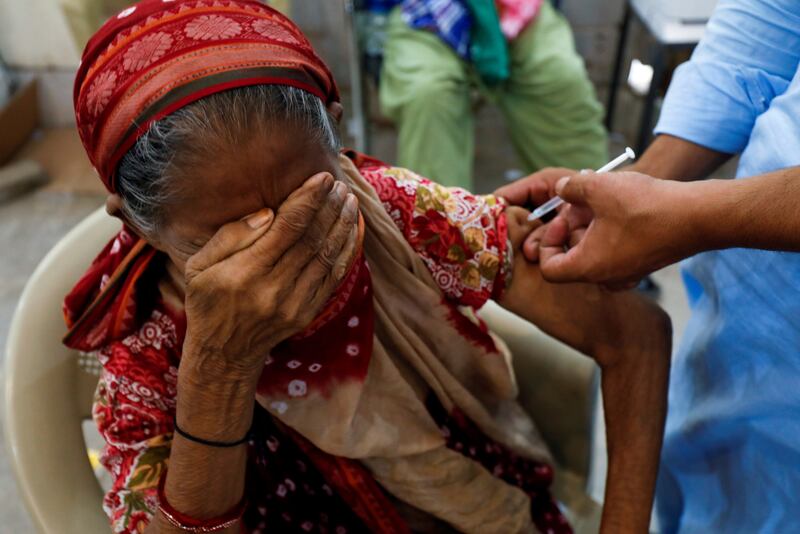 A woman receives a Covid-19 vaccine in Karachi, Pakistan. Reuters