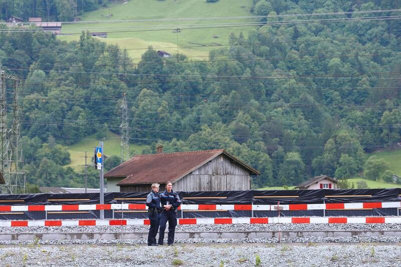 Swiss police officers stand on guard for the opening ceremony. Ruben Sprich / AFP