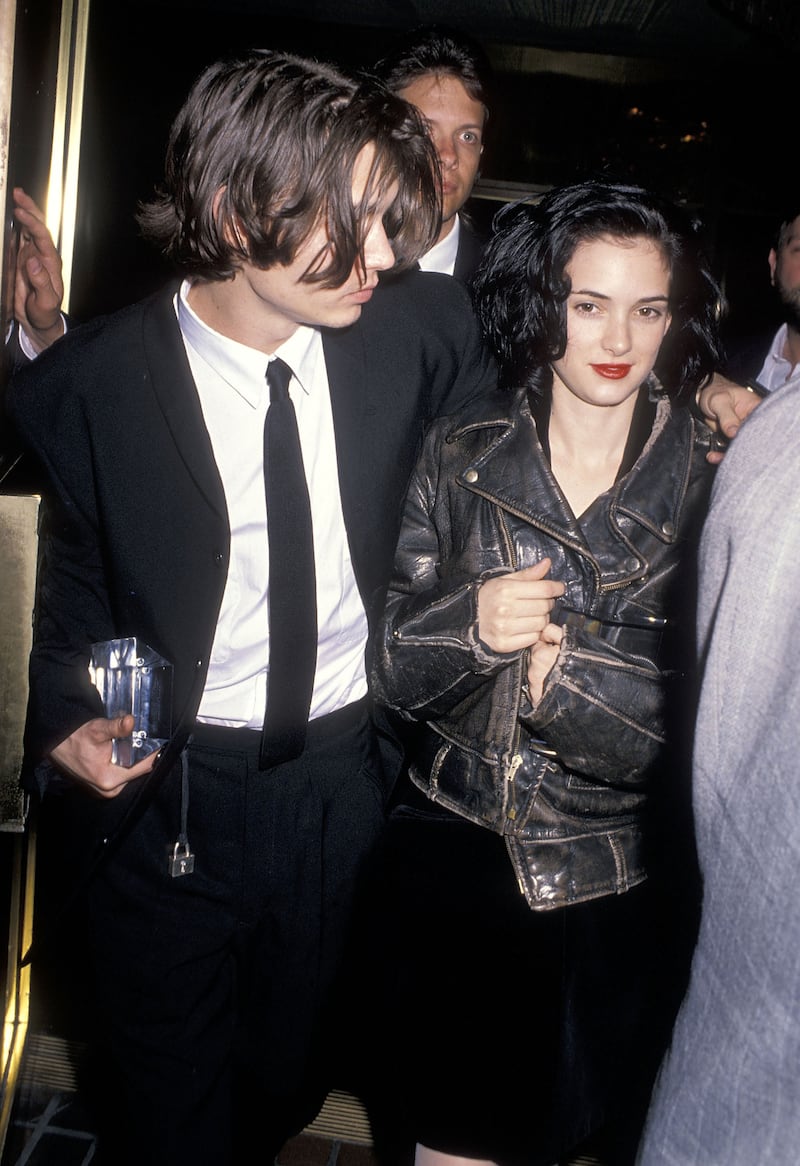 Winona Ryder, accompanied by Johnny Depp, wears a leather biker jacket to the 1990 Nato/ShoWest Convention on February 8, 1990 at Bally's Hotel and Casino in Las Vegas, Nevada. Getty 