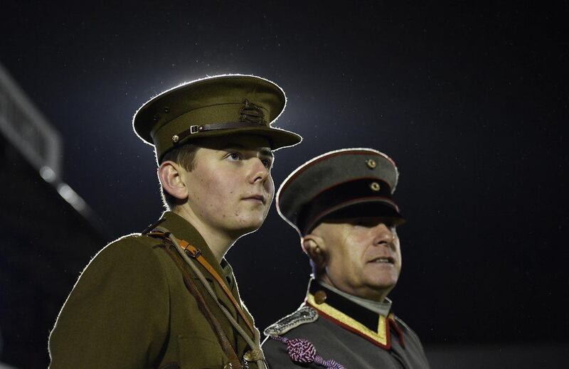 Officers wearing replica World War I British and German army uniforms watch Wednesday's football match between the British and German armies in Aldershot to commemorate the 100th anniversary of the match played during the Christmas Day Truce in 1914 during World War I. Toby Melville / Reuters