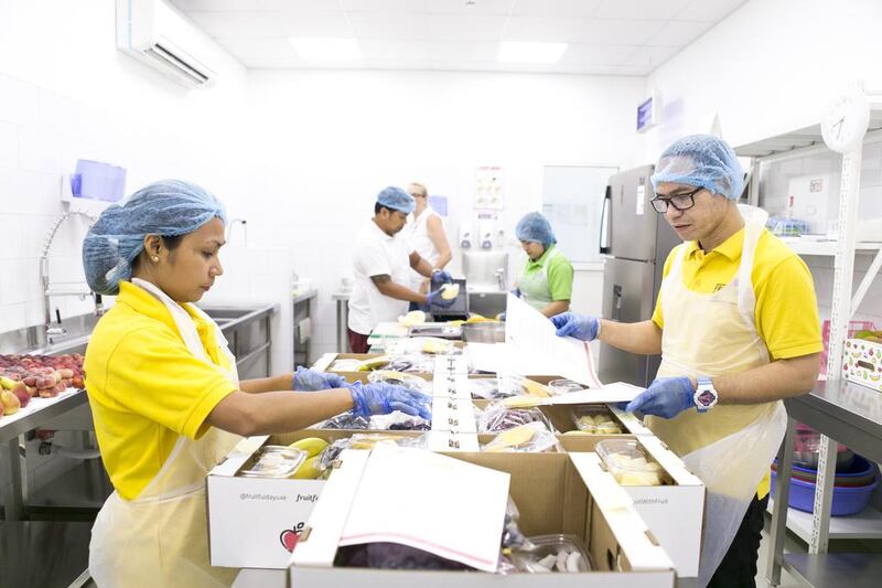 Staff prepare fresh fruits for delivery to clients at the company's sorting facility. Reem Mohammed / The National