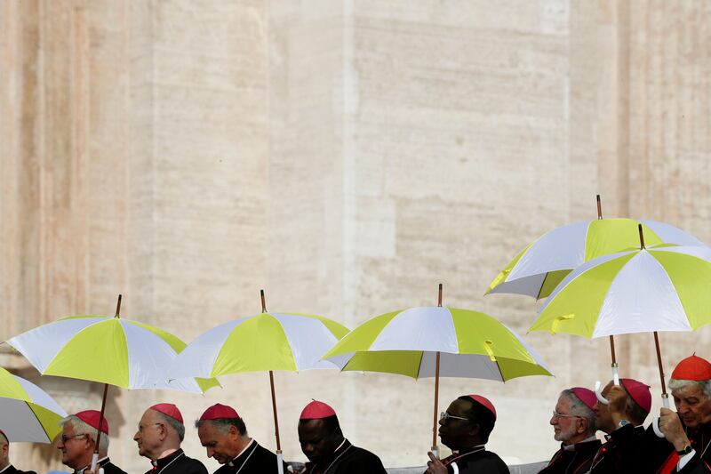 Bishops hold up umbrellas on a sunny day in St Peter's Square at the Vatican. Andrew Medichini / AP Photo