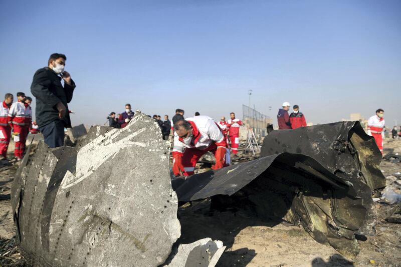 TEHRAN, IRAN - JANUARY 08: Officials inspect pieces of the plane at site after a Boeing 737 plane belonging to a Ukrainian International Airlines crashed near Imam Khomeini Airport in Iran just after takeoff with 180 passengers on board in Tehran, Iran on January 08, 2020. All 167 passengers and nine crew members on an Ukrainian 737 plane that crashed near Iran's capital Tehran early Wednesday have died, according to a state official. (Photo by Fatemeh Bahrami/Anadolu Agency via Getty Images)