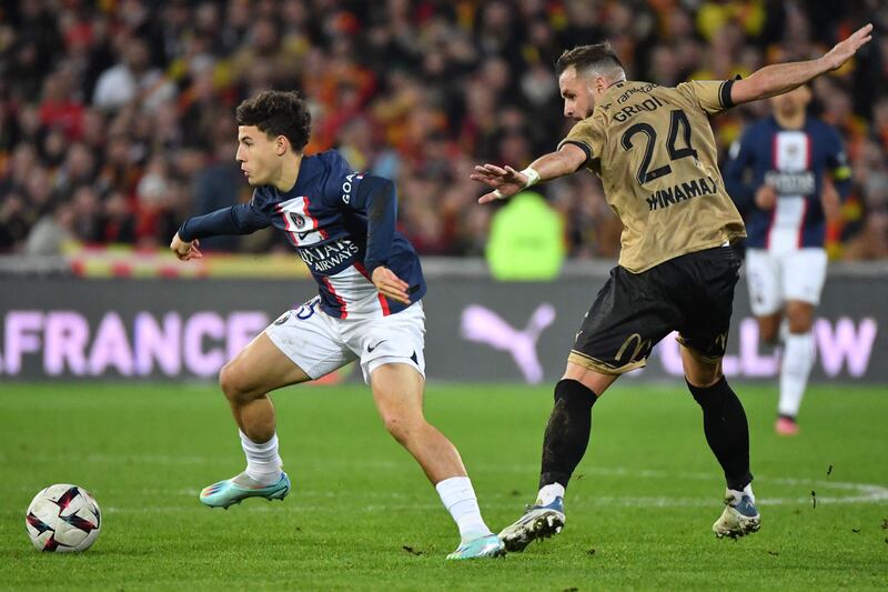 Paris Saint-Germain midfielder Ismael Gharbi, left, fights for the ball with Lens defender Jonathan Gradit. AFP
