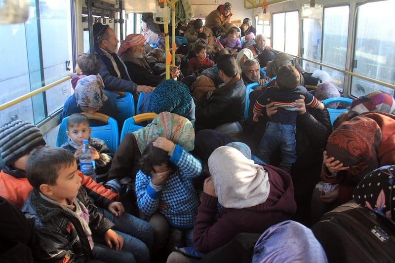 Residents from the mostly Shiite Syrian villages of Foua and Kefraya, which are besieged by opposition fighters, wait in a bus to get the green light from rebels to cross into a government-controlled area of Aleppo province on December 20, 20016. Omar Haj Kadour/AFP

