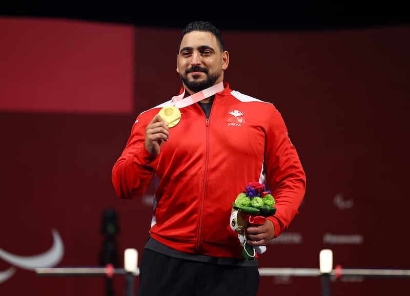 Abdelkareem Khattab of Jordan celebrates on the podium after his gold at the Tokyo Paralympic Games. Reuters